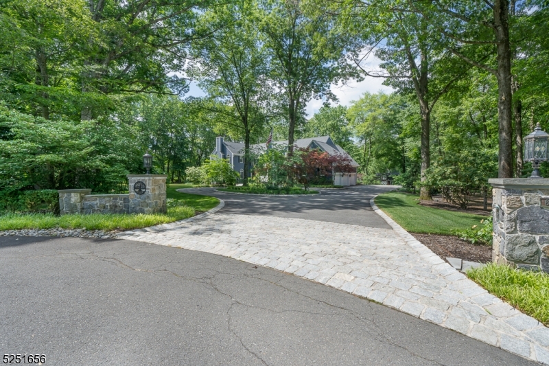 Blue stone Pilars and a spacious circular drive welcome you to this lovingly cared for home which is set on a private park-like landscaped 4 acres at the end of a cul-de-sac, adjacent to Green Acres.  This 6 bd Colonial has it all with no detail overlooked. The grounds offer a multi use sports court- including a tennis court with covered gazebo, basketball, ice hockey and plenty of pickle ball space. A spacious trek deck wraps around the back and steps down to the fire pit area.  As you enter the main doors you are greeted with lots of light where you can admire the expert craftsmanship adorning the magnificent stairwell that sets the stage for luxury, comfort and beauty.  The 1st floor features a warm custom eat-in kitchen with a large honed granite island. The living room offers a serene setting with a fireplace and custom mill work is everywhere. Relax in the family room with vaulted ceilings, a stone fireplace and a custom bar.  The home also offers a convenient first floor bedroom.  The second floor can be reached by a back staircase from the mudroom.  The Primary en-suite has a fireplace, 2 custom walk-ins and a soaking tub overlooking the stunning backyard.  Not to be missed is the newer lower level with a billiards room, office, work-out room and more...All this located within minutes to Morristown, Madison, Mendham, Liberty International Airport, NYC transit,and major highways for convenience. The attractive Harding taxes complete this offering.