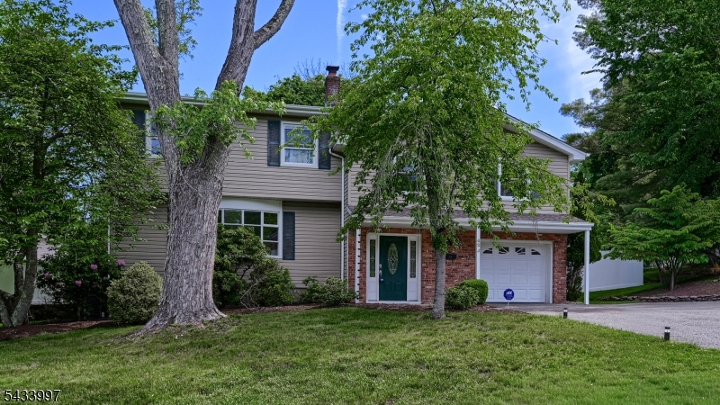 Welcome to 42 Stirling Lane, a spacious and well-maintained 5 Bedroom Split Level set on a private corner property in a desirable neighborhood! An inviting foyer with two closets welcomes you into this warm and functional home. The ground level offers a versatile Den currently used as a Mudroom, Powder Room with Laundry and access to the attached 1 Car Garage. The sun-filled main living area features a spacious Living Room with oversized bay window, formal Dining Room and an updated Eat-in Kitchen complete with granite countertops, stainless steel appliances and ample cabinetry. Upstairs offers 5 Bedrooms including a Primary Suite with full Bath and walk-in closet, plus an additional main Bath. The partially finished Basement expands the living space with a Rec Room ideal for entertaining, gym, playroom or home office, along with storage and utility rooms. Step outside to enjoy the fenced private backyard with paver patio, spacious side yard and large front lawn perfect for outdoor entertaining, gardening or play. A custom shed provides additional storage. Conveniently located near top-rated schools, shopping, restaurants, Whole Foods Market, major highways and NJ Transit bus and train service. A fantastic opportunity to make this wonderful home your own!
