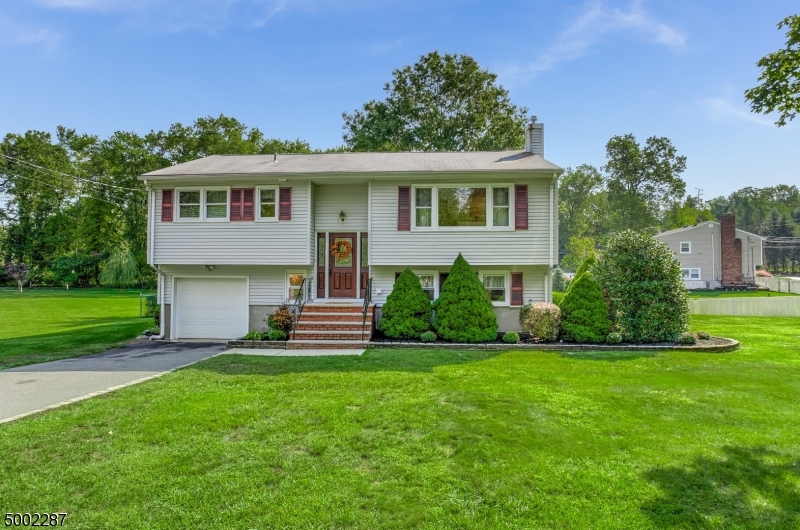This well cared for Bi Level has 4 Beds 2 full Baths with hardwood floors on entire 1st level.  3 Beds & 1 full Bath on 1st floor, with Living, Dining and Kitchen open to each other for an easy flow. A bonus 3 season room that could be converted to 4 seasons is filled with natural light to relax and enjoy the extra large back yard.  The ground level/basement area has a 4th Bedroom, Family room, over sized laundry storage room, 1 full bath and entrance to the garage.  So much room to spread out and entertain.  There is a trex deck off the Family room that is covered by the 3 season rm above so don't worry about rainy weather So close to rt 10, 280, 287, 80 and 24.  Don't miss the opportunity to add your designer touches to this solid very spacious home. Flood Insurance Required. sq footage per owner appraisal