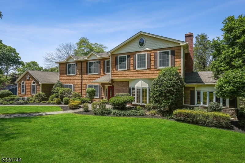 Picture perfect sprawling custom, expanded colonial located in prestigious Wickham Woods with 5 Bedrooms (plus a lower level Bonus Guest Room) and 6 Full Bathrooms including a 1st Floor en-suite Bedroom. Exquisite property with potential for a pool. Close to top-notch schools, restaurants and NYC transportation, this spacious home features a walk-out Lower Level, a fenced-in yard, luxurious Primary Wing + spectacular open concept Chef?s Kitchen / Family Room. 2-story Foyer is flanked by Formal Living with separate Den and Great Room. Chef?s Kitchen features custom cabinetry, high-end stainless steel appliances, granite counters, large center island + additional eat-in area surrounded by windows with direct access to wrap-around deck. Great Room with vaulted ceiling boasts provides access to 2-car attached garage.  Formal Dining Room and 2nd Full Bath complete the main level. 2nd level features 4 Bedrooms (2 en-suite and 2 share a bathroom). Primary Wing features vaulted ceiling, hardwood floors, office with privacy doors, dressing room, Laundry Room, walk-in closet, and retreat-like Bathroom with jetted soaking tub, glass-enclosed shower and double vanity. Expansive Lower Level is walk-out with Recreation Room, 2nd Laundry Room, Game Room with patio access, Media Room, Bonus Guest Room, Full Bath, Workshop and Wine Room. Marvelous yard landscaped to perfection, paver patio with extensive hardscaping, built-in fire pit and planters, fenced-in area + wrap-around deck.