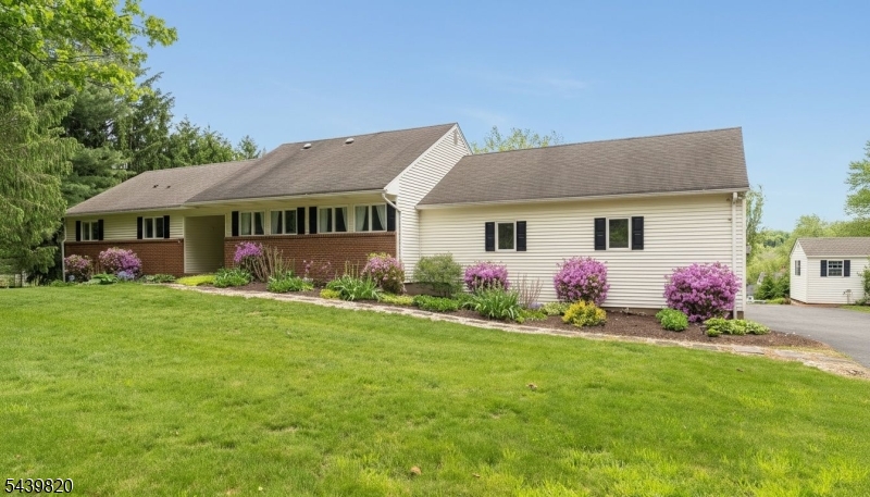 This impeccably maintained and beautifully updated custom ranch checks every box and more. Set on a quiet, tree-lined street with convenient access to Clinton, Flemington, Pittstown, and I-78, this immaculate home sits on a gorgeous 1.53-acre property with an expansive rear deck and scenic countryside views. The open eat-in kitchen with center island is ideal for everyday living and entertaining, flowing into a sunny breakfast area and a welcoming family room with vaulted ceilings and a striking stone woodburning fireplace. Large windows bring in abundant natural light and highlight the surrounding landscape. The main level offers a gracious entry foyer, living room, formal dining room, 3 spacious bedrooms, and two beautifully updated full bathrooms, including a luxurious primary suite with walk-in closet. The spectacular finished walk-out lower level adds exceptional additional living space, featuring a 4th bedroom, office, exercise area, 3rd full bathroom, custom built-ins, laundry area, storage, and sliders to the patio and rear yard. A fabulous oversized 2-car attached garage completes this exceptional property. Don't miss this one!