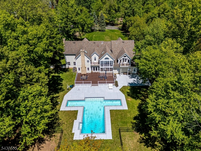 Beautifully nestled on 5+ lush acres, this fully renovated home features 5 bedrooms and 5.5 bathrooms, offering both elegance and comfort in aprivate, serene setting. The welcoming entrance foyer w marble flooring, opens into a spacious sun-filled formal living room with a wood-burning fireplaceand beautiful front-to-back views. A generously sized office, accented by a large bay window, is filled with natural light; The brand-new gourmet kitchen,equipped with high-end appliances, opens seamlessly to the dramatic two-story family room, where an entire wall of windows showcases breathtaking viewsof the backyard and swimming pool. A newly added first-floor in-law suite provides exceptional flexibility for guests or parents living. Upstairs, the luxurious primary suite includes a comfortable sitting area and access to a private balcony. A second primary suite offers a full bath and two walk-in closets.The 2nd floor also features an open loft and leisure area, ideal for a home office, study, or fitness space, as well as a full-size laundry room; Recent upgradesinclude: Kitchen & appliances (2025); All Bathrooms (2025); Hardwood floors (2025); Hot water heater (2025); Septic (2025); Swimming Pool(2025); This exceptional property combines timeless elegance, modern updates, and peaceful privacy truly a dream home.