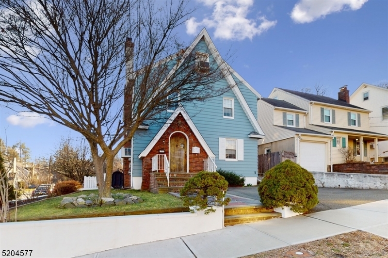 Stunning character, quiet street, true convenience! Beautifully maintained Colonial situated on a corner lot just 20 miles from Manhattan in the Upper Lourdes neighborhood of West Orange. Just few blocks to the Eagle Rock Reservation, close to schools, stores, restaurants & public transportation for an easy commute to NYC. This home has many charming details including stained wood trim & crown molding, rich wood floors & a warming fireplace with a carved wood surround, along with an updated kitchen & bathrooms.  A flagstone walk leads you inside to a vestibule & a large living room centered by the fireplace, adjacent to a the formal dining room wand & a cozy sunroom. The eat-in kitchen is bright & sunny w/granite counters, spacious pantry & cool gray cabinetry. A large deck & patio perfect for entertaining, fenced-in backyard & storage shed. The 2nd floor encompasses 3 generous-sized bedrooms, full bathroom & a good size room that could be used as an office or a room for guests. A spacious bedroom on the finished 3rd floor could also be used as a family room with multiple closets & large skylights windows offering an unobstructed view of the Manhattan skyline. The finished basement level includes a recreation room, full bathroom, laundry area, storage space & garage entrance. All this plus an attached 1-car garage, an additional paved area for extra parking & proximity to two county parks, golf courses & Turtle Back Zoo.  Conveniently located, and waiting to be enjoyed!