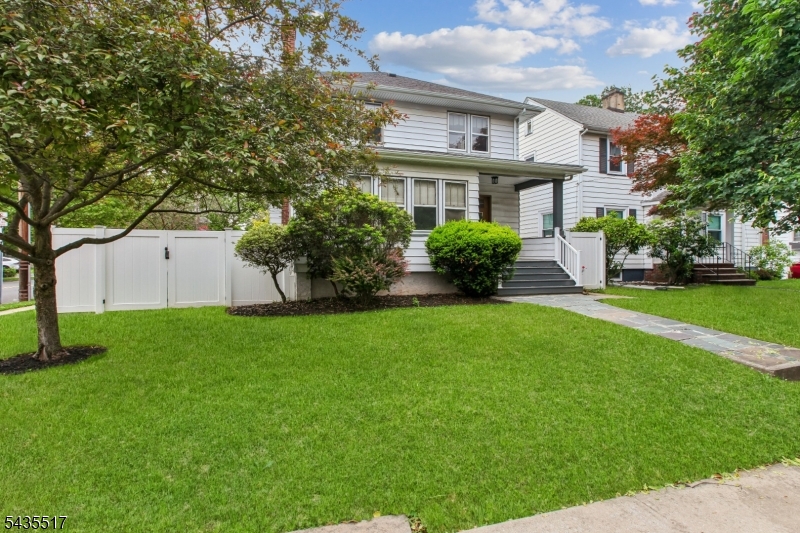 Classic charm meets modern convenience in this beautifully maintained Rahway Colonial. Rich hardwood flooring, original wood detailing, and sun-filled living spaces create a warm and welcoming atmosphere throughout the home. The main level offers an inviting living room centered around a fireplace with custom built-ins, a formal dining area perfect for gatherings, and a bonus den/office space tucked behind elegant French doors   ideal for remote work, a playroom, library, or relaxing reading retreat.  The renovated kitchen features contemporary finishes, stainless steel appliances, generous cabinetry, and functional counter seating for casual dining and entertaining. Upstairs, spacious bedrooms provide comfort and flexibility, while the second-floor laundry adds everyday convenience. Outside, enjoy a fully fenced backyard designed for both privacy and entertaining, complete with a paver patio, mature landscaping, and a detached 2-car garage. A full basement offers additional storage and future potential.  Perfectly situated near the Rahway train station, downtown dining, shopping, parks, and major highways, this home combines character, space, and commuter-friendly convenience in one exceptional package.