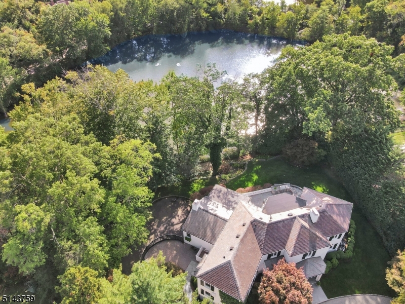 An opportunity of a lifetime. From the pages of a luxury magazine, this completely renovated and meticulously maintained residence nestled in the heart of Old Short Hills on half an acre showcases both sophisticated high design and alluring warmth. Imagine purchasing an impeccably decorated house that feels just like home on the very first day. One where luxurious custom finishes throughout were all carefully selected to perfection. This exquisite waterfront home features breathtaking views of North Pond, 3 bedrooms, 3 full & 3 half baths, a flowing floor plan, soaring ceilings, 2 grand wood-burning fireplaces, chef-inspired kitchen, spa-like master suite, 2 car garage, hardwood flooring throughout, all-brick exterior, slate roof and expansive grounds.