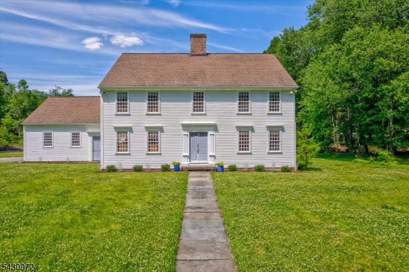 In the unique enclave of Roseland's Holmehill neighborhood, 1 Canoe Lane is a rustic, elegant colonial that evokes true New England style. Its commodious layout features 5 bedrooms, 4 full bathrooms, 1 half bathroom, a library, and an open kitchen with a working Rumford fireplace. The kitchen lets out to a serene back porch, complete with a view of a sprawling backyard. Situated on a large, flat plot of land, the home's vision was lovingly brought to reality with intentional detailing. Custom hand milled woodwork and solid wood doors are found throughout. Its architecture follows the design principles of functionality and symmetry. Adding to the layout's fluidity, there are four different stairwells and three entry points through the back of the home. The old growth heart of pine shiplapped flooring can no longer be sourced as it originates from 18th century homes. The rose head nails and hardware on its doors were exclusively hand wrought by the master blacksmith Joe Tucker. Lighting inside and outside of the home was crafted thoughtfully with Americana influence. Storage and closet spaces are extensive. Other note-worthy features include a built-in central vacuum system, two-zone central air system, two-zone heat system, a large 2-car attached garage, and a basement with ample storage. Located within close proximity to Roseland's markets, restaurants, boutique shopping and top-rated schools. Making this your home can truly mean you have found an oasis for years to come.