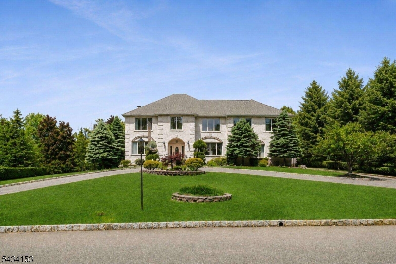 Built in 2009, this impressive custom Colonial offers a grand presentation, expansive living space, and exceptional entertaining potential inside and out. A circular driveway with parking for 17 cars sets the tone for this beautifully maintained home. The spacious foyer welcomes you into sun-filled interiors featuring hardwood floors and oversized windows throughout. The formal living room flows seamlessly into the inviting family room with a wood-burning fireplace, creating the perfect setting for everyday living and gatherings alike. The chef's kitchen is designed to impress with two oversized refrigerators, a large center island with bar seating, abundant cabinetry, and direct access to the family room overlooking the backyard and deck ideal for entertaining guests. A formal dining room filled with natural light provides an elegant space for hosting. Completing the main level is a first-floor bedroom, full bath, and separate laundry room for added convenience. Upstairs, the expansive primary suite features a private bath and walk-in closet, accompanied by six additional bedrooms, a sitting room, and two full bathrooms. The finished walkout basement offers a large recreation area, half bath, and utility room. Outdoors, enjoy a spacious fully fenced backyard retreat featuring a heated in-ground pool surrounded by mature landscaping and expansive patio space, ideal for summer entertaining, outdoor dining, or relaxing in complete privacy.