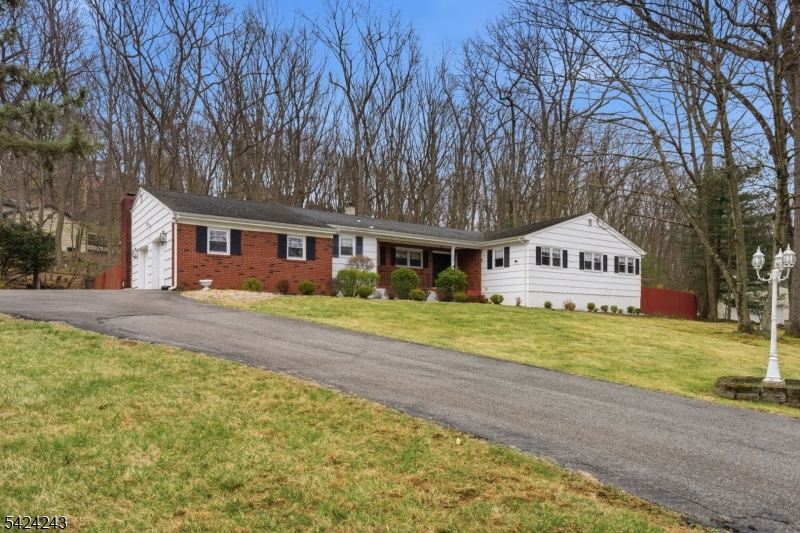 Sprawling 4 bedroom ranch set on a beautiful 1+ acre corner lot in one of Denvilles most desirable, quiet neighborhoods. This well loved home, owned by the same family since 1983, offers an incredible opportunity to create your dream home with a great layout, solid bones, and endless potential. Featuring 2 full baths including a primary suite, a classic foyer entry, spacious living room, formal dining room, and a sun filled kitchen with pantry space. The inviting family room showcases soaring vaulted ceilings with exposed beams and a brick-faced wood-burning fireplace, with sliders leading to a large rear deck overlooking a private, wooded setting, perfect for relaxing or entertaining. Additional highlights include a 2 car garage, dedicated laundry room, electric car charger outlet, and a full unfinished basement offering tremendous potential for future living space. An in ground pool exists on the property (not used in many years) and is being sold as is. Public utilities, central air conditioning and baseboard heating add to the homes practicality. Located in the heart of Denville, known as the Hub of Morris County, enjoy top rated schools, a vibrant downtown filled with shops, restaurants, and community events, plus easy access to NJ Transit, major highways, and NYC commuting options. A rare chance to customize a home in a premier location with space, privacy, and long-term value.