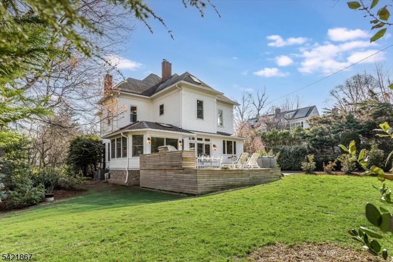 Welcome to this quintessential, stately Montclair residence where timeless elegance meets modern comfort set on one of the town's most sought-after streets. Enter through the orig. front drs to soaring ceilings, abundant natural light, & exquisite period dtls including oversized pocket doors & intricate moldings, creating a warm, inviting atmosphere.The main lvl offers a versatile layout w/ a gracious frml LR, space for a prvt office, & an expansive dng rm perfect for hosting gatherings & holiday meals. At the heart of the home is a chef's kitchen feat. an oversized island, wet bar w/ wine fridge, & loads of cabinetry.Just beyond, the spacious FR impresses w/ cathedral ceilings & skylights that flood the space w/ light. This seamless kitchen/FR combo is ideal for everyday living & entertaining, complete w/ radiant heated flrs & direct access to the beautifully landscaped backyard & deck for effortless indoor-outdoor flow.Upstairs, the prim suite offers a priv bath & WIC. The 2nd flr includes 3 add'l bdrms & full bath, w/ 1 currently used as a sitting rm. The 3rd flr adds 2 lrg bdrms & full bath perfect for guests or flex living space. A breathtaking wraparound frnt porch, lush landscaping, & a newly built modern rear deck with built in TEC grill complete this exceptional home just a stones throw from town, dining, shops & NYC direct train. This is Montclair living at its finest: elegant, spacious, and effortlessly welcoming.