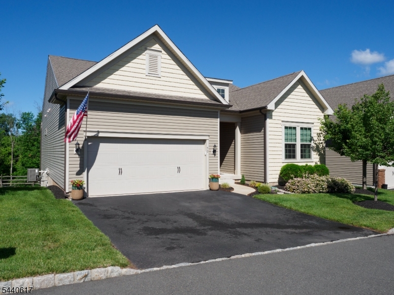 Nearly 2800 SF of elegantly finished living area is yours to enjoy in this gorgeous 3 BR, 3 BA Hunterdon Creekside "Abbeyville" model with a spectacular full finished walkout ground level. You'll be sure to appreciate substantial upgrades, including a $35,000 lot premium for this prime location with private backyard! The main living level features an open-concept plan with gourmet center island chef's kit with double wall oven, 5-burner gas cooktop with pro grade hood, built-in microwave, granite counters, breakfast bar, upgraded 42" cabinetry, recessed & pendant lights, tiled backsplash, hardwood flooring and sunny dining area with glass door to deck & private views! The adjoining Great Room features lofty high ceilings, crown moldings, expansive windows, combo ceiling fan/light and hardwood flooring.  This main living level also offers an Office, Laundry Room, 2 BR's & 2 full BA's, including the luxurious Master Suite! The MBA is handsomely upgraded with double bowl Quartz topped vanity & frameless glass shower enclosure.  Downstairs is approx 1120 SF (in addition to 1660 SF on main level) with 3rd BR & 3rd full BA + Spacious FR & Game Rm and includes upgraded 9' ceilings, recessed lighting, an array of windows + sliding glass door to backyard. This level also includes 2 large unfinished storage rooms. Community amenities include pool, tennis, clubhouse, pickle ball & bocce ball courts, playground, walking trails and many planned activities & events!