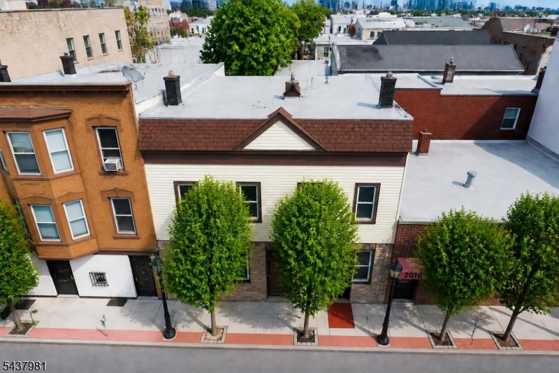 Rare Historic Four-Family with Original Craftsmanship & NYC Commuter Convenience. This distinctive four-family property blends historic character with modern upgrades, offering exceptional flexibility for owner-occupants and investors. The property will be delivered completely vacant at closing, with all four apartments available for immediate occupancy or rental income. Featuring 8 bedrooms and 7 full bathrooms across three levels plus a finished basement, the home showcases original hand-laid hardwood floors, intricate woodwork, and craftsmanship rarely found today. The first-floor unit offers 3 bedrooms and 2 full bathrooms. A finished basement is connected to the first-floor living space and includes an additional bedroom, full bathroom, expanded living area, and both interior and exterior access. The second-floor unit features 2 bedrooms and 3 full bathroom, while the third-floor unit offers 1 bedroom and 1 full bathroom. An additional fourth apartment provides added flexibility and income potential. A comprehensive renovation completed in 2008 included a new roof, siding, insulation, windows, plumbing, electrical systems, kitchens, and updated bathrooms. Conveniently located near Boulevard East with direct NJ Transit service to Manhattan, this rare vacant four-family combines historic charm, modern updates, and excellent commuter access, making it an outstanding opportunity for both investors and owner-occupants.