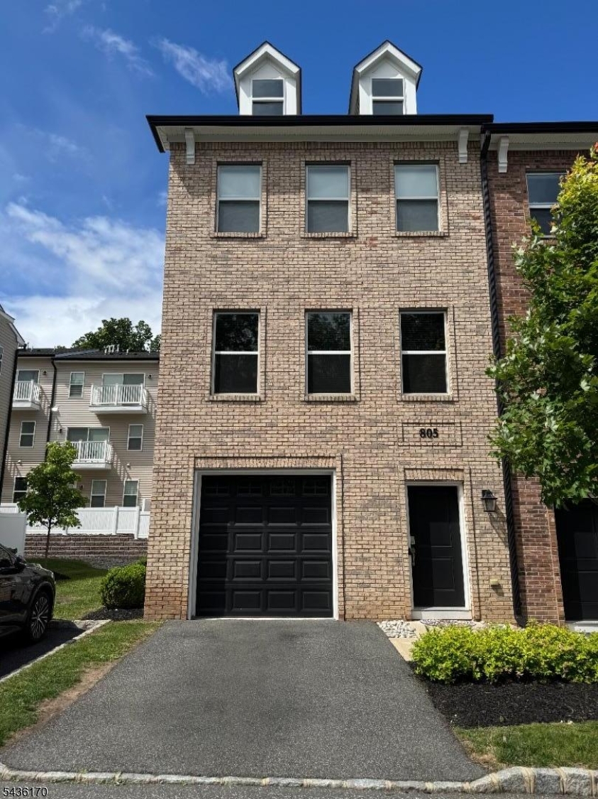 Stunning 2,144 sq ft corner-lot townhouse built in 2019 offering 4 beds, 3.5 baths across 3 floors in a small, quiet Little Falls community. First floor features a guest suite with full bath, private patio access, and extra-large coat closet with built-ins. Second floor boasts an open-concept living/dining/kitchen layout with massive island, granite counters, built-in coffee bar, marble powder room, and balcony. Third floor primary suite features dual vanity, full marble bath, walk-in closet with built-ins, and private balcony. Two additional bedrooms plus crown molding throughout third floor. Smart home package includes Google Nest thermostats, Ring doorbell, Ring camera above back door, smart lock, MyQ garage opener, and EV Level 2 charger. HOA covers landscaping & snow removal. Corner lot brings abundant natural light. Walk to Little Falls Train Station. Minutes to Routes 23, 46, 80, GSP, NJ Turnpike, and Willowbrook Mall. Move-in ready!