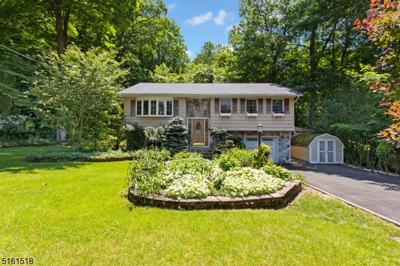 PEACE AND TRANQUILITY ABOUND! Beautifully updated, nothing to do but unpack. Hardwood and stone floors throughout top level. Large living room with  bow window allows for lots of natural light. Updated kitchen boasts granite counter tops, beautiful cabinets, pantry with pullout shelves, SS Appl's and a garden window for your fresh herbs. The dining room with sliders to the deck which leads to a gazebo and side yard. What a great place to relax. Down the hall you will find 3 bedrooms & main bath. Just down the stairs, a very large newly tiled family room, office, full bath, laundry and utility room. Access to garage with outside entrance finishes off the lower level. New A/C 2006. New hot water heater 2014, New roof 2016, New driveway 2017 and many other updates. Minutes to Cranberry lake, membership is optional. Just minutes to NYC Bus, Train Station, stores, restaurants, 206 and Rt 80.