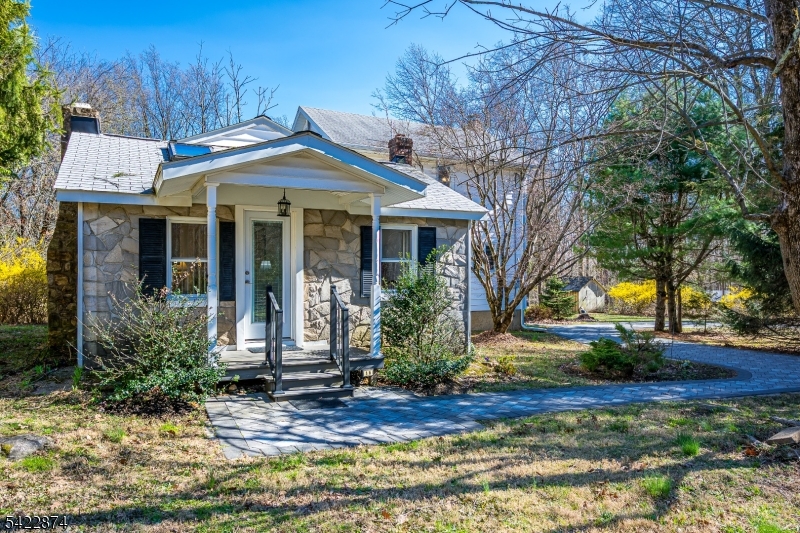 Tucked away on over an acre of property on a private road, surrounded by preserved open space, this custom ranch with anexpanded upper level with large bedroom and full bath, offers the rare combination of peaceful seclusion and everydayconvenience, and just 12 minutes from town. Set along a private road, this home delivers a true escape from the worldlifestyle while still being close to everything you need. The main level features an inviting living room, dining area, and openkitchen designed for easy living and entertaining. Three bedrooms on main level, a charming sunroom, and an adorable frontporch create warmth and flexibility, while the rear door opens to expansive, level grounds that transition into a woodedbackdrop, your own private oasis. Upstairs, the fourth bedroom provides private space with a separate full bathroom.Thoughtful skylight placement allows natural sunlight, into the living room, front bedroom, and dining/kitchen area. The frontbedroom wall was designed to be easily removed to create a larger living room. The exterior featuring a stunning Cambridgepaver circular driveway and walkways, adding both curb appeal and functionality. Additional highlights include: newer roof,new boiler, two basements, one perfect for storage and utilities, new oil tank has 30-year warranty. If you have beensearching for privacy, land, and a lifestyle that feels like a retreat, this is the one. Property is located in Long Valley, NJ, Hunterdon County.