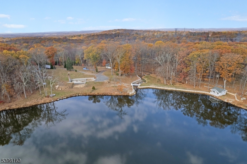 SIMPLY AMAZING! This is a rare, secret spot that feels miles away from everything but is minutes from commuter roads and conveniences. This 8 acre dream is waterfront and farm assessed (garlic and fruit trees). HOUSE TO BE BUILT. The original house foundation and architectural plans for a rebuild are included. A well-built garage and small cabin are currently standing. A second home could be built for farmhand relatives. Welcome home to Valentines Pond.