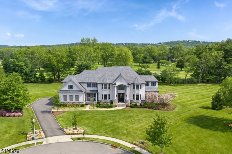 Nestled in Denville's most luxurious enclave, this exceptional home of distinction sits on the flagship lot in a private community of just 26 premier residences. Perfectly positioned in a serene cul-de-sac, this golf course property spans 1.22 acres with 430+ feet of frontage on Rockaway River Country Club, offering unmatched privacy and expansive green views rarely offered in a suburban setting, defining true elevated living and exclusivity. With 5,900+ sq ft, this custom home features a grand 2-story foyer, coffered ceilings, distinctive entryways, and refined millwork. The custom-designed chef's kitchen with built-in dining area and Taj Mahal quartzite flows into a sunroom and expansive family room, ideal for open-concept living. Five bedrooms with en-suite baths include a first-floor in-law suite. The primary suite offers a sitting room and double-sided fireplace, walk-in custom closets, and spa-like bath with heated floor. The private setting is perfect for a pool, while the basement can showcase a home theater, great room, or bar. Located in sought-after Denville, known for top-rated schools, vibrant downtown charm, and ideal NYC or commuter access with mass transit, nearby EWR, or private airports. Enjoy nearby county park with 550+ acres of woods and trails, plus Hallmark-style downtown with dining, shopping, and community events. A rare opportunity to acquire a luxury estate with a unique blend of upscale suburban living and small-town charm. Visit 8philhowerct . com