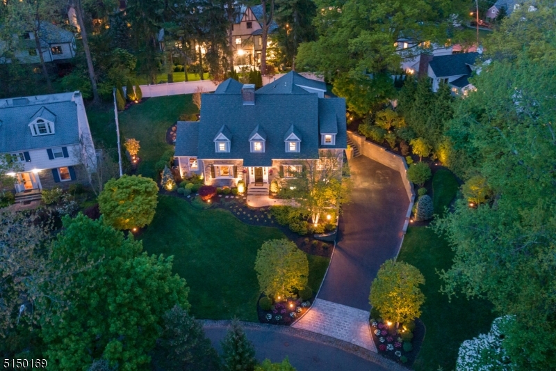 MAGAZINE WORTHY GEM located in the heart of prestigious Old Short Hills incredibly close to Glenwood School, Short Hills Train Station, Hartshorn Arboretum. Perched beautifully on a tree-lined winding street, this stunner has been brilliantly renovated from top to bottom w/ every modern convenience imaginable. All renovations/additions, indoor & out, are exacting to meld seamlessly w/ the original home. Fantastic for entertaining on any scale. One-of-a-kind Gourmet Chef's Kitchen w/ Hibachi Grill, Kegerator, Wolf/Sub Zero/Miele appliances & magical Breakfast Room. Sundrenched Family Room off Kitchen w/ coffered ceiling opening up to idyllic backyard. 2 Home Offices! Elegant Living & Dining Rooms. Butler's Pantry. "Smart  home w/ every high-tech upgrade imaginable. Glorious Primary Suite w/ Walk-In Closet for 2 & bath rivaling a 4 Seasons. All other bedrooms sundrenched w/ custom closets & on-trend baths (all ensuite or Jack & Jill). Third Level w/ fantastic Home Theater w/ Wet Bar/Kitchenette, Guest Suite, Half Bath & abundant storage. Lower Level w/ gorgeous 1400 Bottle Wine Room, Recreation Room, Custom Built-Ins, fabulous Mud Room w/ custom storage, Server/IT Room, Full Bath & 2 Car Garage. Desirable 2nd Floor Laundry & auxiliary Laundry in Mud Room. Extremely private, lush property, outstanding outdoor entertainment spaces including hand cut stone hardscaping, wraparound Bluestone Patio, Fire Pit & perennial gardens. Every inch of this home must be seen to be appreciated!