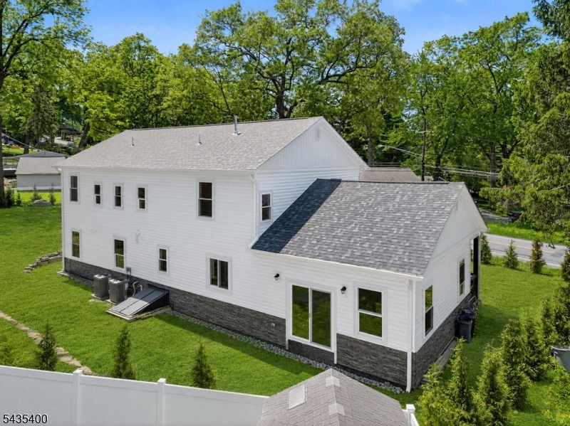 Brand-new construction offering modern comfort, quality craftsmanship, and a Sparta lifestyle just moments from the Lake Mohawk plaza, restaurants, shopping, and Sparta's highly rated school system. Set on a double lot, this beautifully designed 4-bedroom, 3 full bath Colonial offers approximately 2,300 sq ft of living space (excluding garage/basement) and features a welcoming covered front porch, dramatic 400 sq ft great room with soaring 14-ft ceilings, oversized 2-car garage with 10-ft ceilings, mudroom, formal dining room, and an expanded primary suite with walk-in closet and dual vanity bath. The designer-inspired kitchen features stainless steel appliances, granite countertops, and flows seamlessly into the main living areas ideal for entertaining and everyday living. Additional highlights include wood and tile flooring, high ceilings, multi-zone cooling, public water, natural gas, and abundant natural light throughout. Features include all new electric, plumbing, roof, gutters, siding, windows, upgraded water service, and a brand-new 4-bedroom septic system. Rear blue stone patio to be installed. Enjoy nearby hiking, golf, skiing, dining, and year-round outdoor recreation that make Sparta and Sussex County such a sought-after destination. Conveniently located near the Lake Mohawk area without associated dues. A rare opportunity to own move-in ready new construction with luxury finishes, commuter convenience, and small-town living.