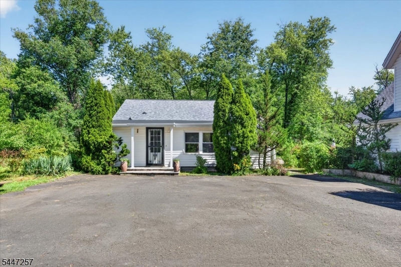 Discover the rare combination of tranquility and convenience at this 2 bedroom, 1 bathroom home, privately nestled on nearly an acre surrounded by mature trees in desirable Belle Mead. Enjoy the feeling of complete seclusion without isolation while remaining just minutes from shopping, dining, Route 206, Princeton, and major commuting routes. Natural light fills the home through oversized windows overlooking the wooded landscape, while the updated kitchen flows seamlessly into the main living area. The spacious primary bedroom features a walk in closet, and the spa inspired bathroom offers a glass enclosed shower and separate soaking tub. Step outside to enjoy a spacious patio, lush gardens, a detached two level garage with a workshop, and an expansive loft offering exceptional space for hobbies, recreation, storage, a home office, or creative pursuits. Recent improvements include a new roof (2026), oil tank (2024), water heater (2021), and furnace (2018).