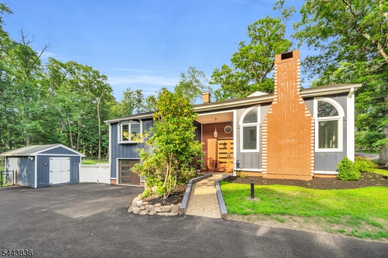 Welcome to this beautifully expanded ranch in desirable Old Tappan, offering spacious living, high-end finishes, and a resort-style backyard. The bright eat-in kitchen is designed for both everyday living and entertaining, featuring new ZLINE appliances, a 60-inch refrigerator, four ovens, two dishwashers, and two sinks. The kitchen flows seamlessly into a banquet-sized dining room, while the inviting living room showcases a dramatic floor to-ceiling fireplace and oversized windows. Custom Brazilian hardwood flooring and beautifully renovated designer bathrooms enhance the home throughout. The main level features a spacious primary suite with a private bath and generous closet space, plus three additional bedrooms, includinga second en-suite, and an additional full bath. The expansive walk-out lower level offers a large family/recreation room, full bath, laundry area, and abundant storage. Professionally landscaped, the fenced backyard is an entertainer's dream with a sparkling in-ground pool complete with a waterfall, a full outdoor kitchen, and multiple areas for relaxing and entertaining. Completing the home are a two-car attached garage equipped with a 220V electric vehicle charger and an extended driveway. A rare opportunity to enjoy luxury indoor-outdoor living in Old Tappan with the added benefit of lower taxes.