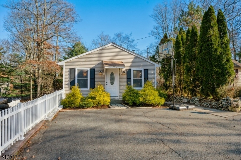The perfect starter home or downsizer!Fully renovated Ranch with two bedrooms, one full bathroom, a finished walkout basement, and a deck is ready to move in and enjoy! Special features include central air conditioning, a whole house generator, an oversized driveway, and a well pump, water heater, softener, and oil tank all less than five years old. This cozy home features an open concept layout with an updated kitchen, beautiful Pergo flooring, lots of natural light, and a deck overlooking the private back yard. The main level includes an open living room, dining area, and kitchen. The kitchen is updated with fresh white cabinets, custom glass tile backsplash, and ample counter and cabinet space. The main level continues with a full bathroom, a primary bedroom with access to the deck, and a second bedroom.The full finished basement offers even more living space that could be used as a recreation/family room, office, along with a small bonus walk-in closet, a large storage space, and outside egress to the back yard. With parking for up to five cars in the extra-wide driveway and a beautiful deck and back yard to enjoy cooking, dining, and playing, this home is perfect for warm weather entertaining. All this and proximity to schools, stores, eateries, and scenic Lake Hopatcong.