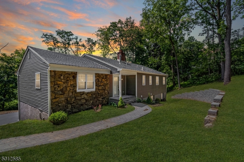 Newly renovated home in Millington NJ has been rebuilt from TOP to Bottom. No expense was spared and literally everything is new in this amazing home! 5 large full Bedrooms w/ Master en-suite. 3 Full Baths in total. Custom kitchen with a huge island with views of the protected lands. Vaulted ceilings, large sliders and windows bring in tons of natural light. Fireplace, new hardwood floors and huge separate custom deck and patio spaces for outdoor entertainment. The private park like setting with exceptional views and privacy make this an entertainers dream home! A unique opportunity to live in a worry free new home with a warranty and amazing views! A must see! Minutes to NYC train and bus, Rt 78 and 287. Top Long Hill Twp Schools, Malls, Shopping.  Fully renovated with over $350,000 in renovations.
