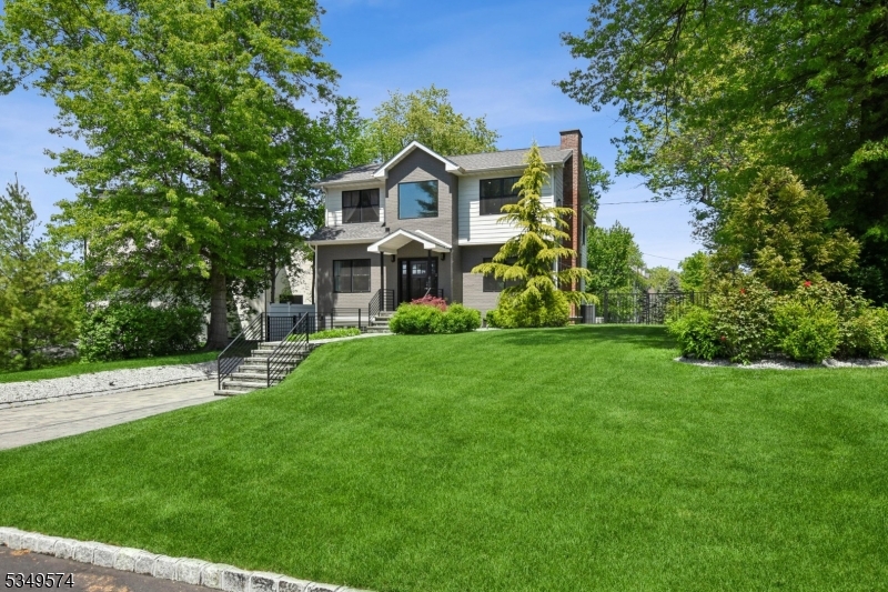 A RARE opportunity to own a masterfully rebuit modern colonial where timeless elegance meets modern luxury. Completely rebuilt in 2018, this extraordinary 5-bedroom, 4 full & 2 half-bath home blends classic architecture with refined, contemporary design. Step into a sunlit, open floor plan curated for both sophisticated entertaining and relaxed everyday living. Formal and casual spaces flow effortlessly, enhanced by designer fixtures and meticulous details. The heart of the home offers the perfect setting to host in style or unwind in comfort. A large deck with clear glass balustrades was added to enjoy the beautifully landscaped property.The main level features an open-concept living room, dining room, kitchen, family room, powder room, and a bedroom suite. Upstairs are 4 bright bedrooms and 3 full baths, including a spacious, sun-filled primary suite. The walkout lower level includes a large rec area, gym, powder room, and garage.Set on a lush, level lot that offers privacy and a peaceful backdrop for outdoor gatherings or quiet reflection. Located minutes from top-rated Millburn schools, NYC trains, Newark Airport, Short Hills Mall, fine dining, and cultural attractions. This home is more than a residence it's an elevated lifestyle in one of NJ's most desirable communities.